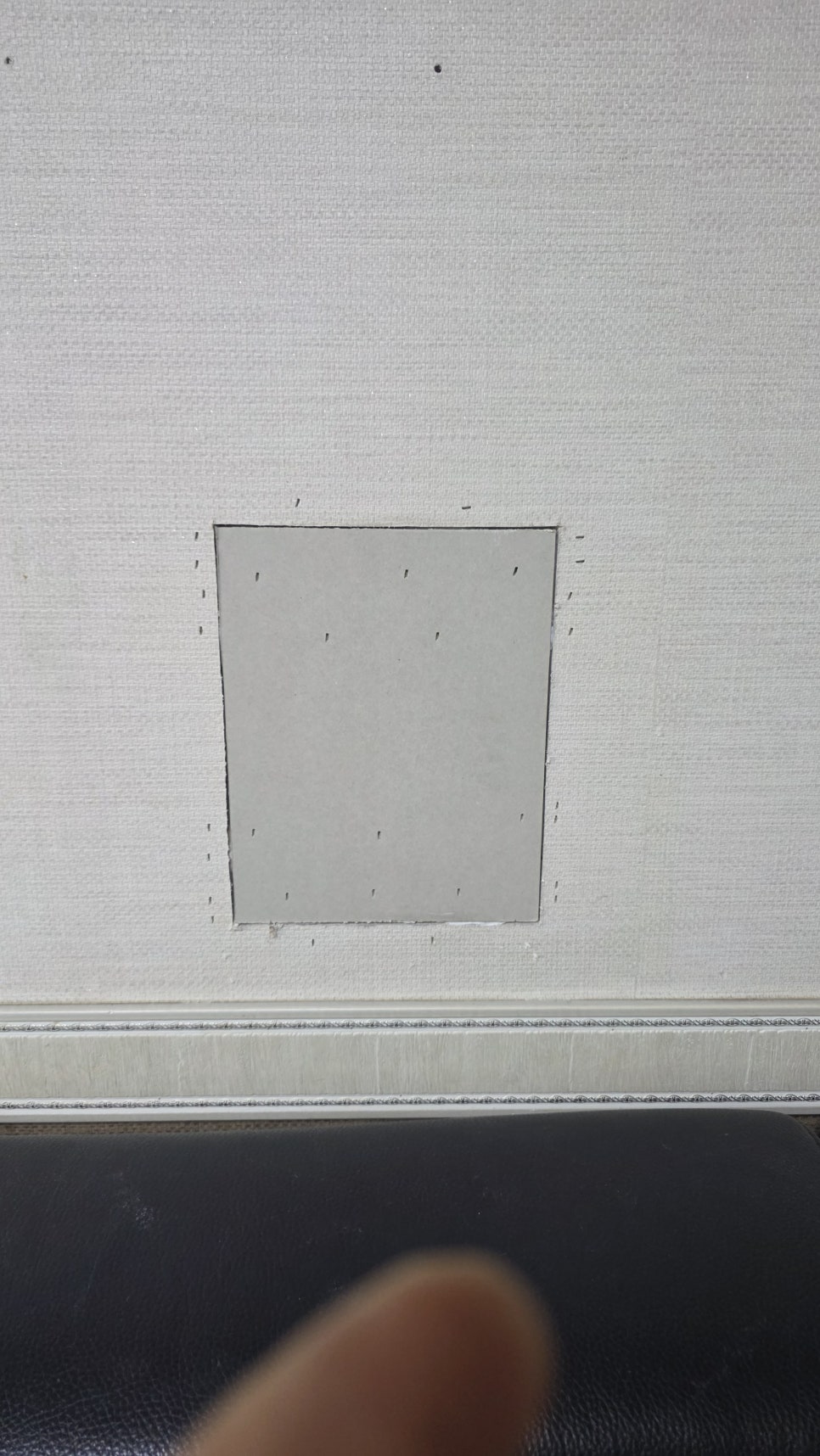 New drywall patch secured in the wall opening