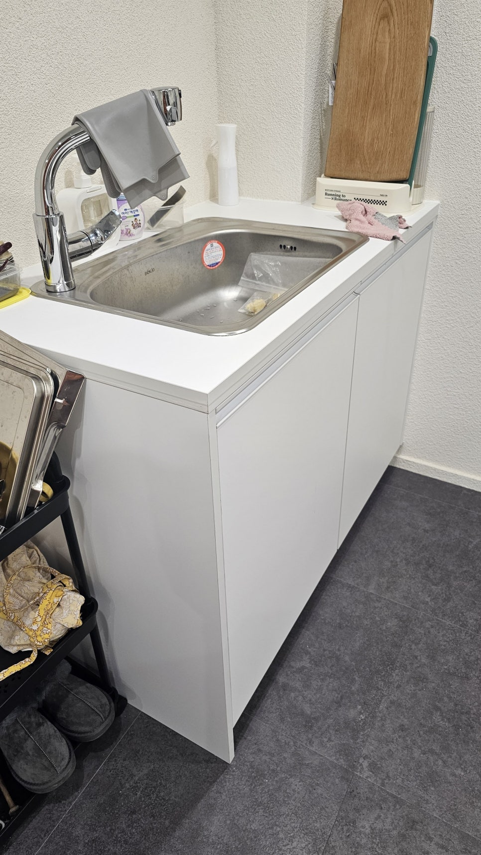 Commercial water meter installed inside a Korean shop sink cabinet