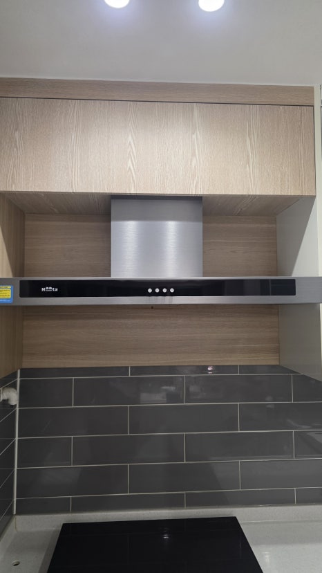Finished custom range hood cabinet with lift-up access door