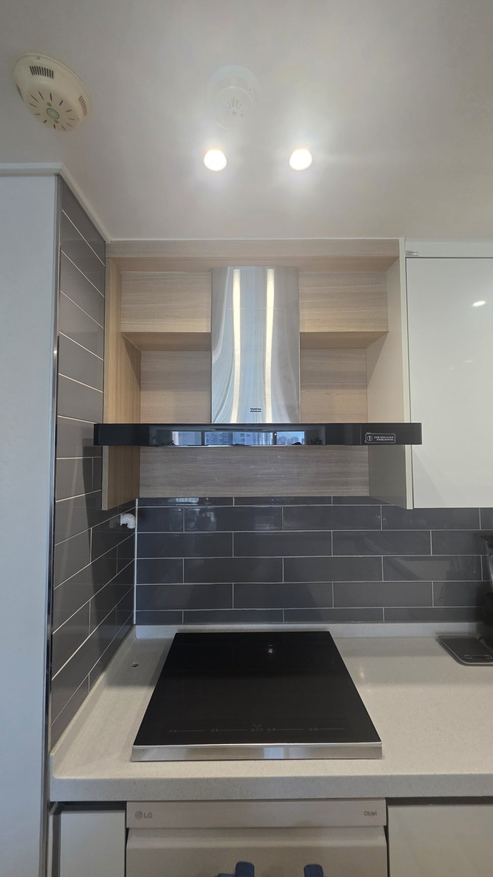 Old chimney range hood with boxed-in ductwork in a Korean apartment kitchen