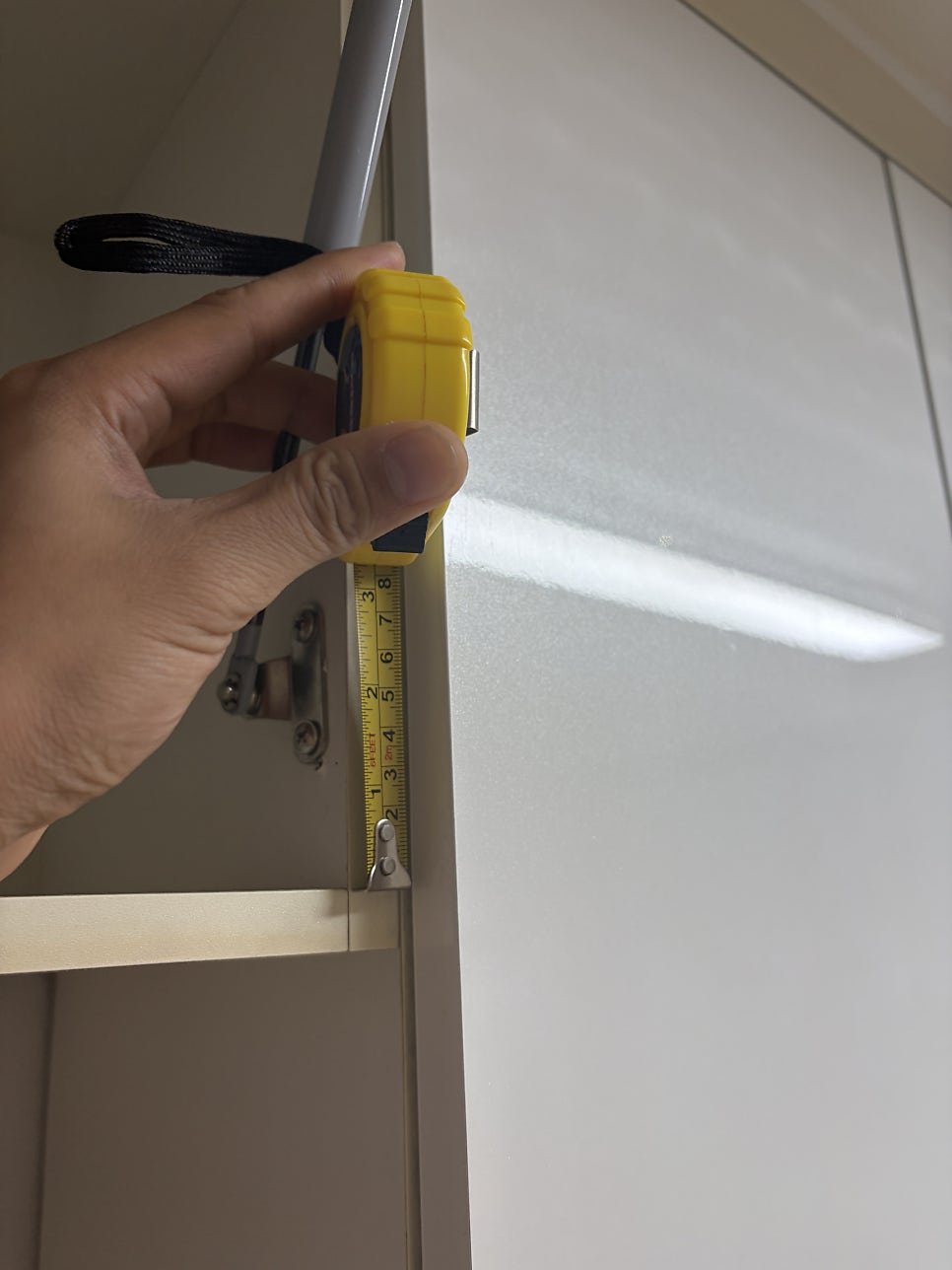 Kitchen upper cabinet blocking refrigerator clearance in a Korean apartment